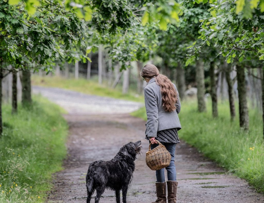 Natasha our forager with her dog, holding a basket ready for foraging.