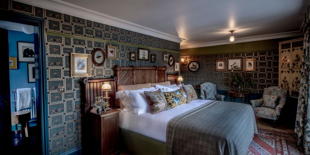 Zoology bedroom featuring king size bed and printed wallpaper