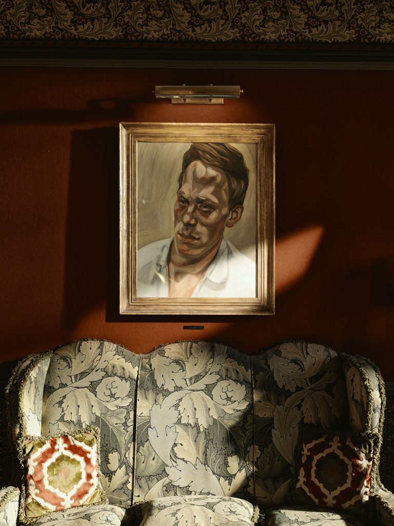 Lucien Freud's painting hung on the orange wall of the hotel lobby