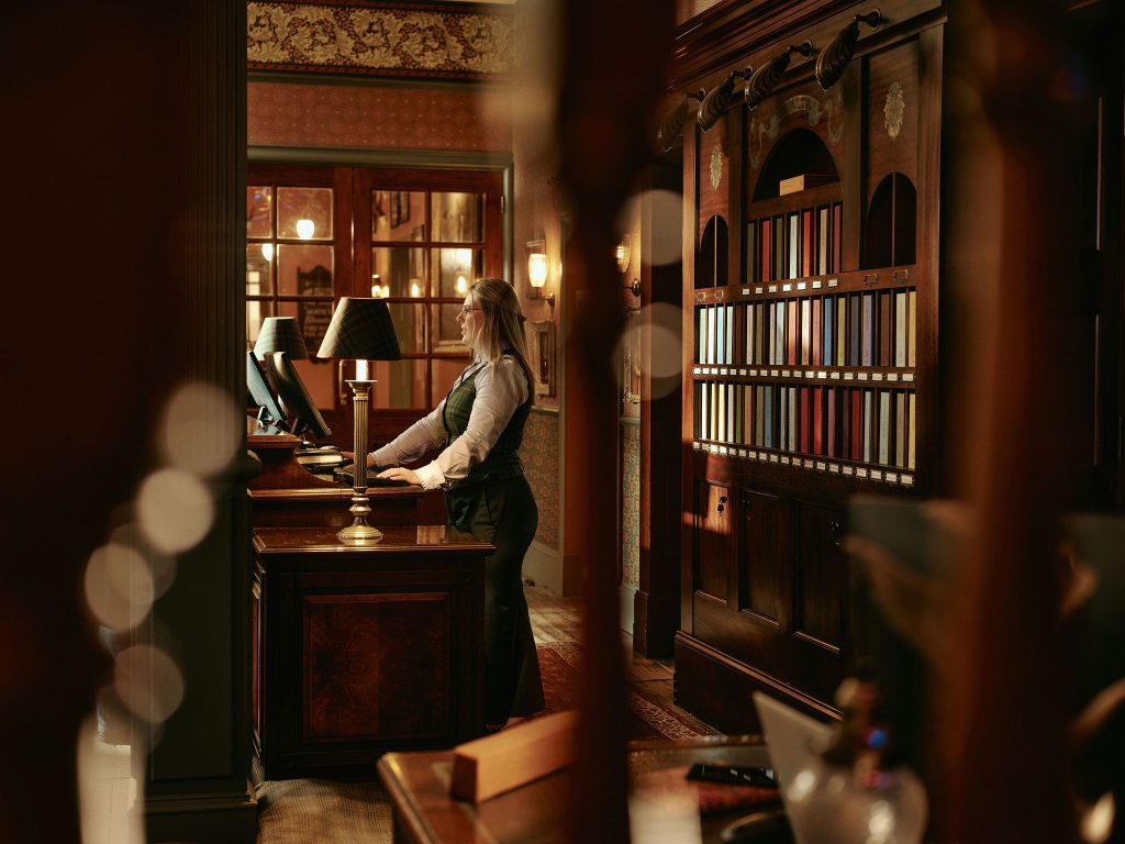 A staff member stood at reception waiting to greet a guest