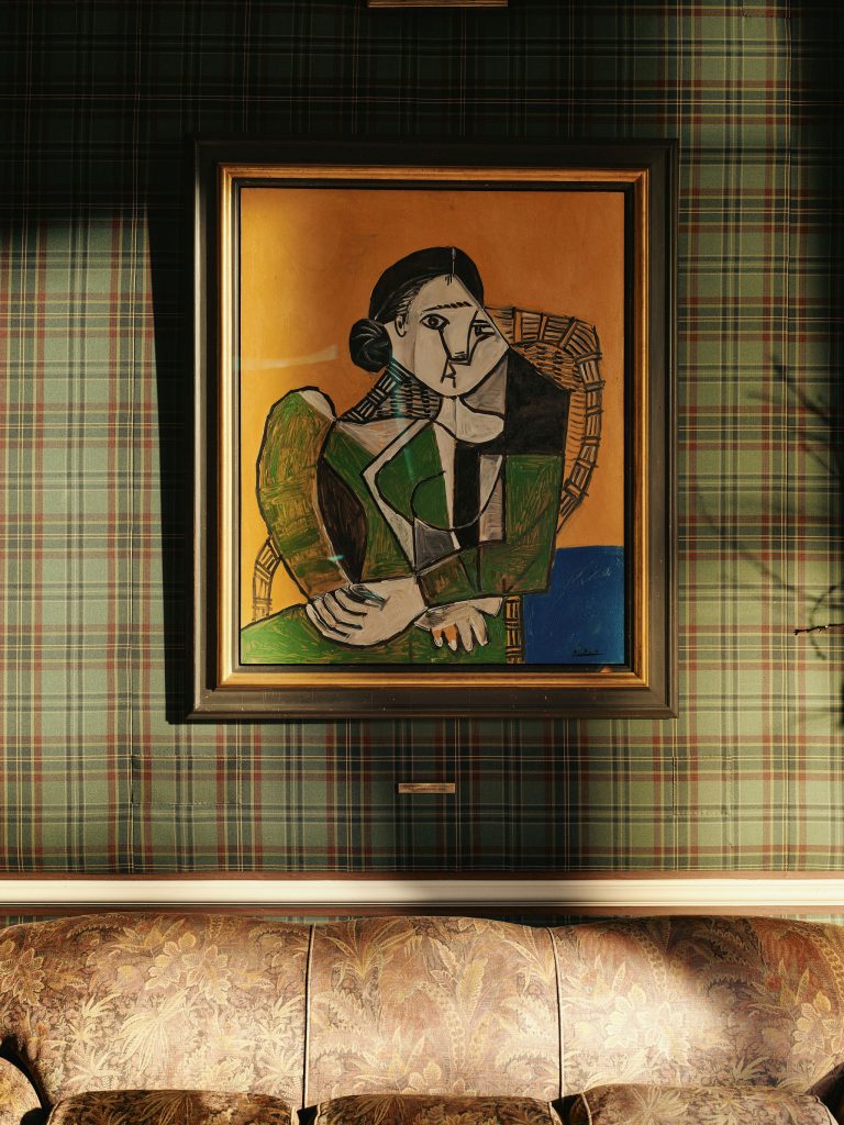 Pablo Picasso's Femme assise dans un fauteuil (Woman seated in an armchair) hung on the wall in the Drawing Room