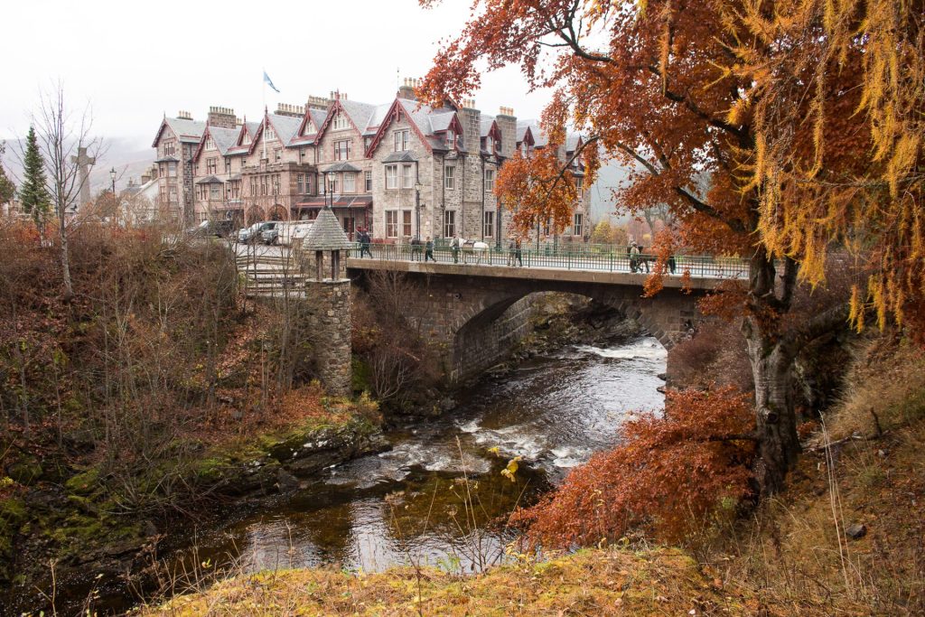 The Fife Arms hotel and surrounding golden orange foliage in autumn