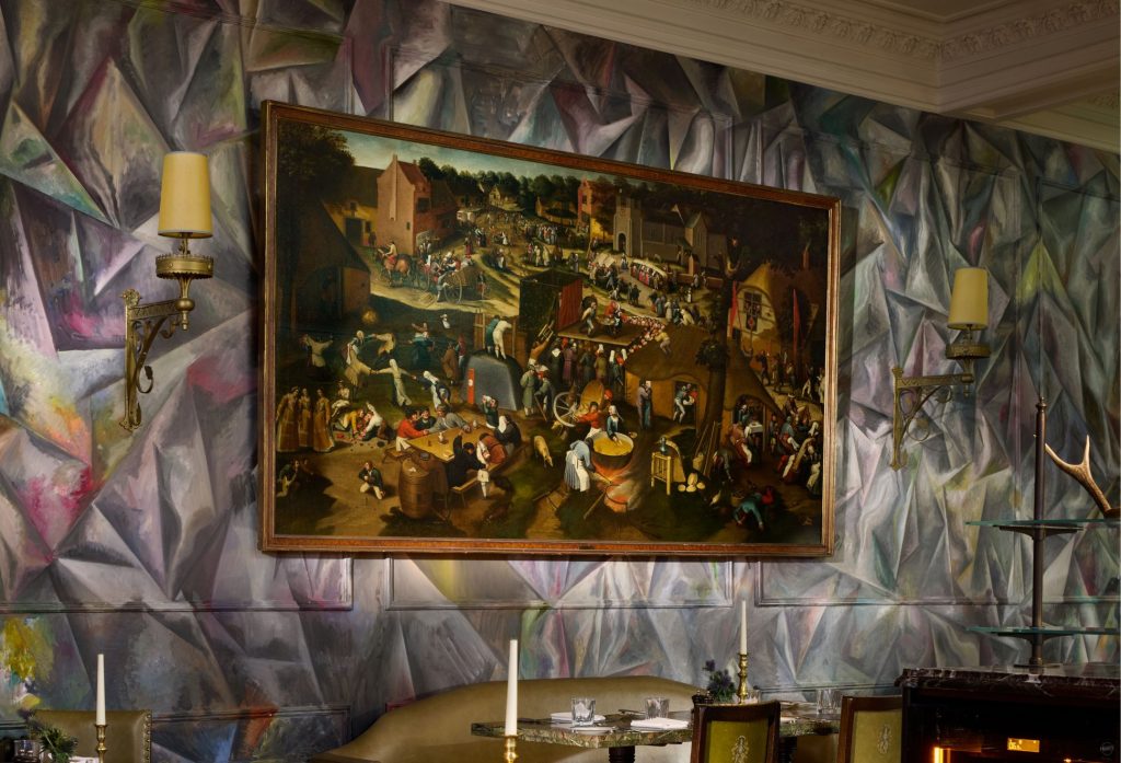A Brueghel painting hung on an abstractly painted wall in The Clunie Dining Room in Braemar, Scotland.
