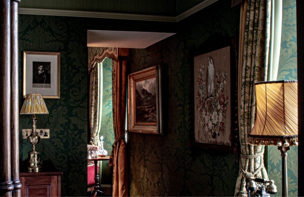 Paintings hanging on green walls in the Earl of Aberdeen suite.