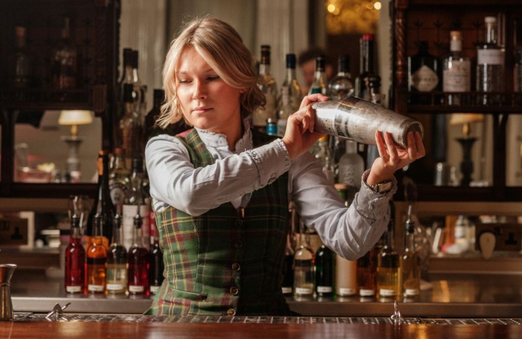 A woman shaking up cocktails in Elsa's Cocktail Bar