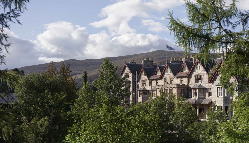 Exterior of the fife arms hotel with cloudy sky in the background