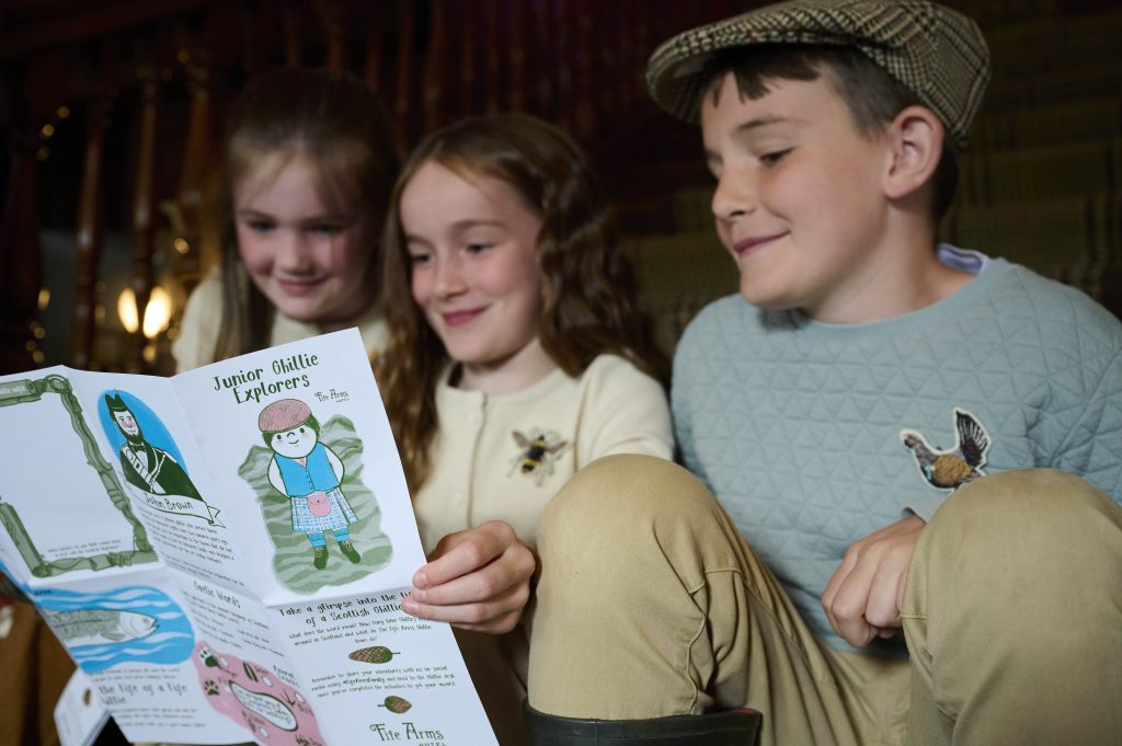 Children together looking at activities on a piece of paper