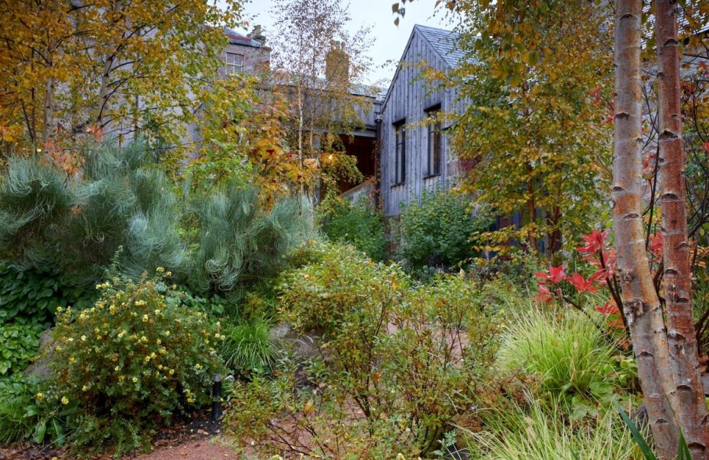 The side of the hotel viewed through the garden