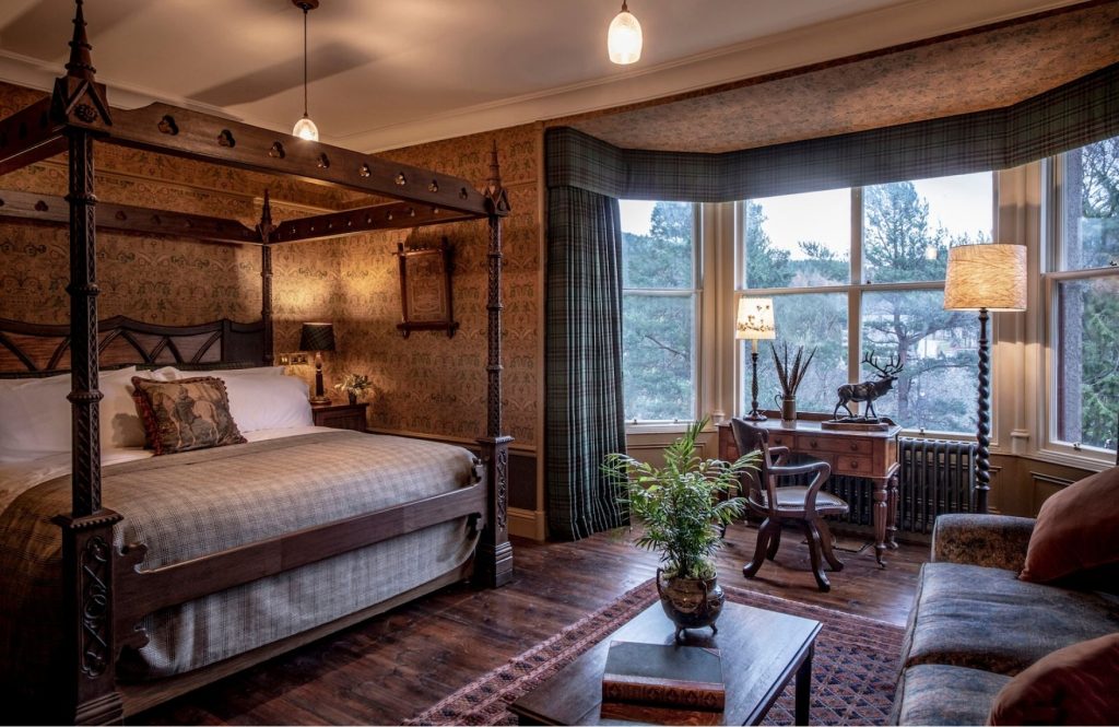 A four-poster bed and bay windows in the John Brown suite