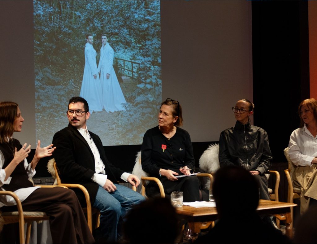 Nurturing talent talk on-stage at Festival of Fashion with five speakers and a screen behind them