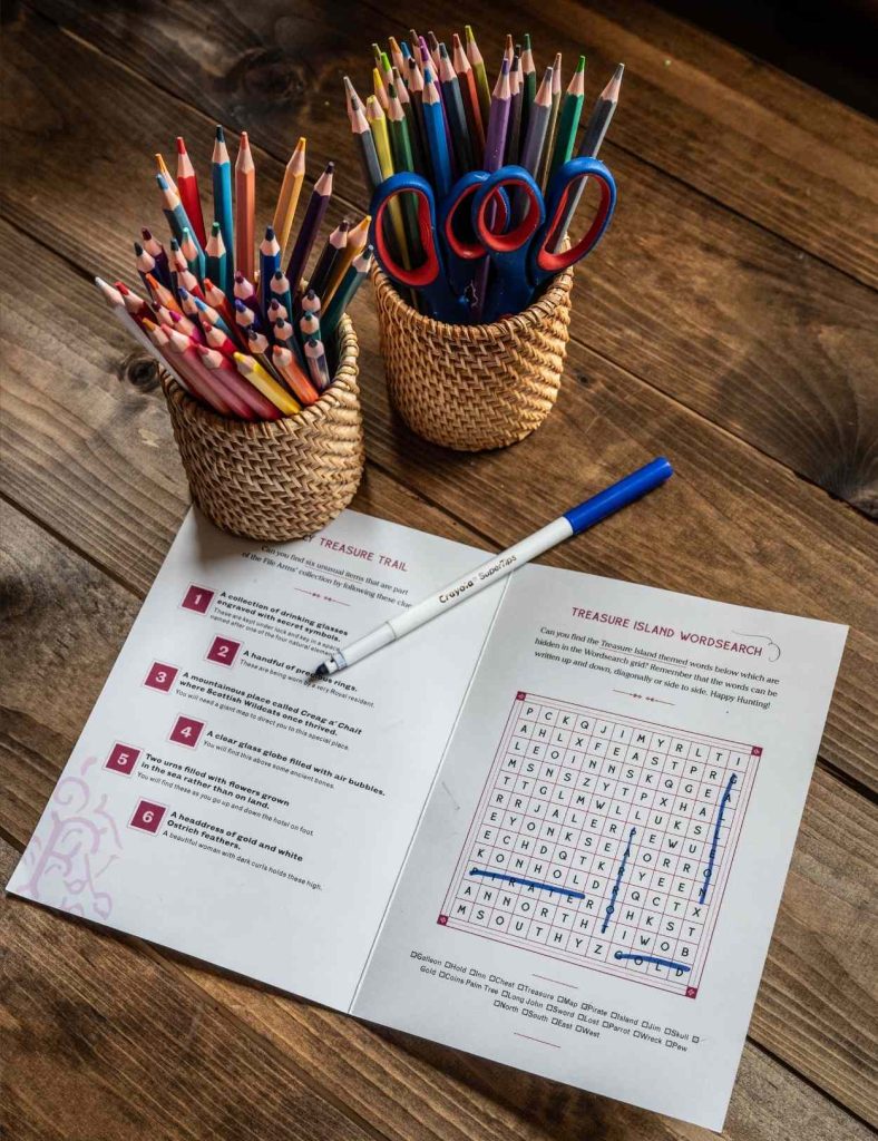 Family treasure hunt on a table with two post of pencils