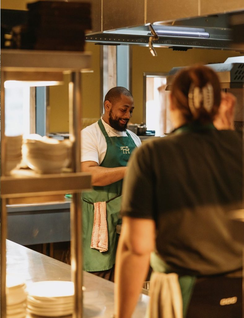 Kitchen team talking in the hotel kitchen