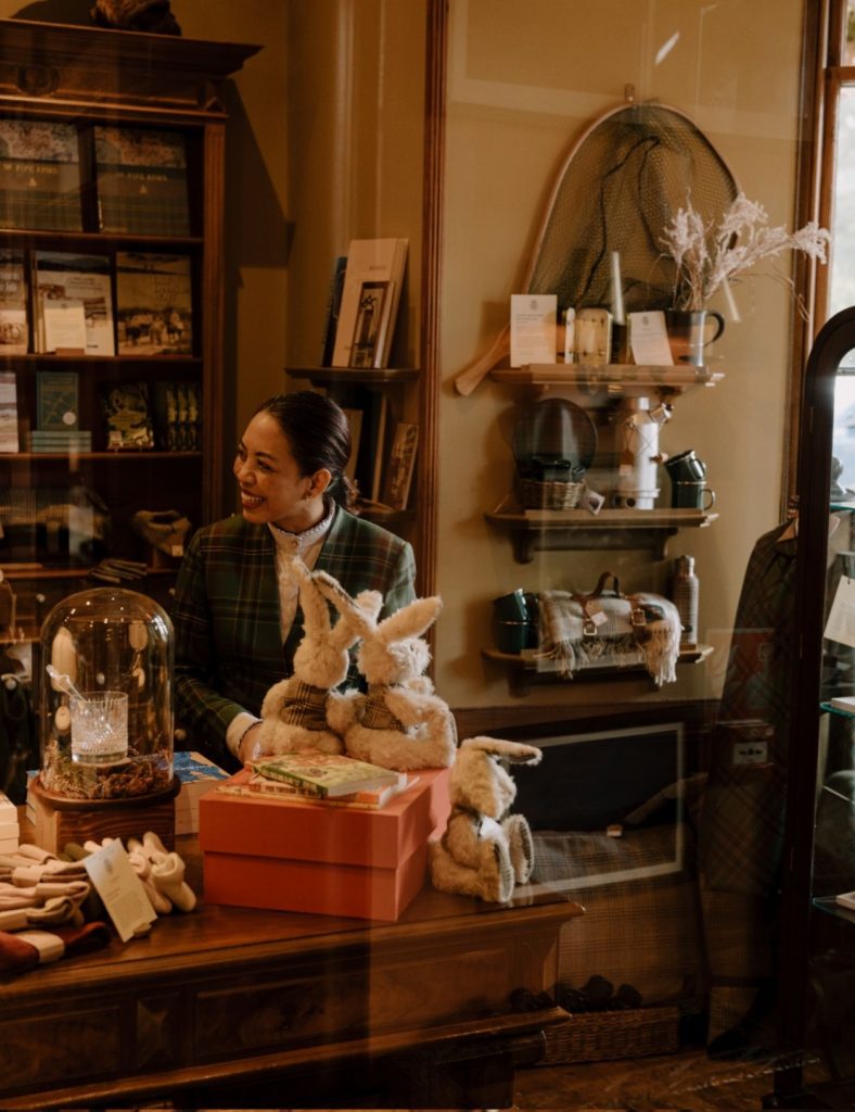 Shop team member smiling at a guest with teddies in the foreground