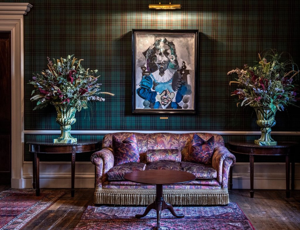 The Picasso artwork hung on the walls in the drawing room with a comfy sofa and table in the foreground