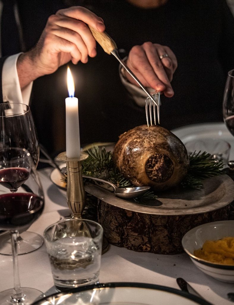 A man cutting into the haggis at a Burns Night celebration.