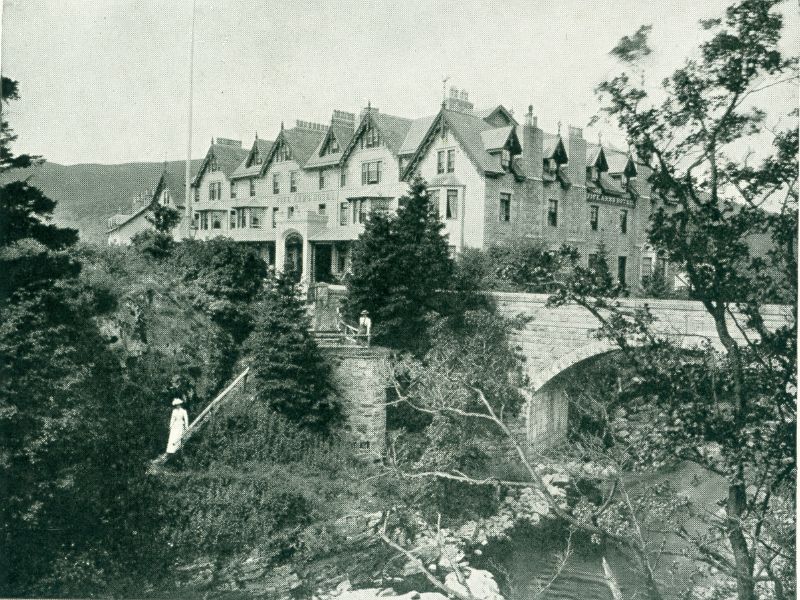Exterior of the Fife Arms hotel with the Clunie River and bridge in view