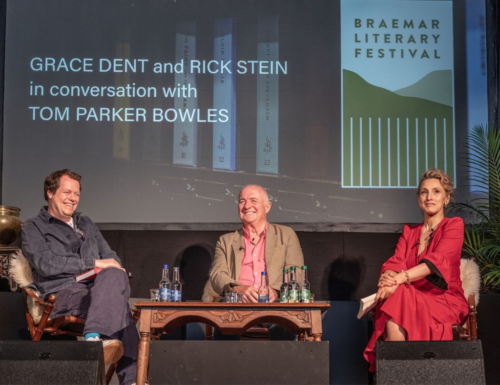 Tom Parker Bowles, Rick Stein and Grace Dent seated on a stage having a panel discussion at the Braemar Literary Festival.